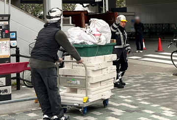 港区の駅下区画での搬出作業現場で交通誘導警備中の警備員3（2025.02.01）